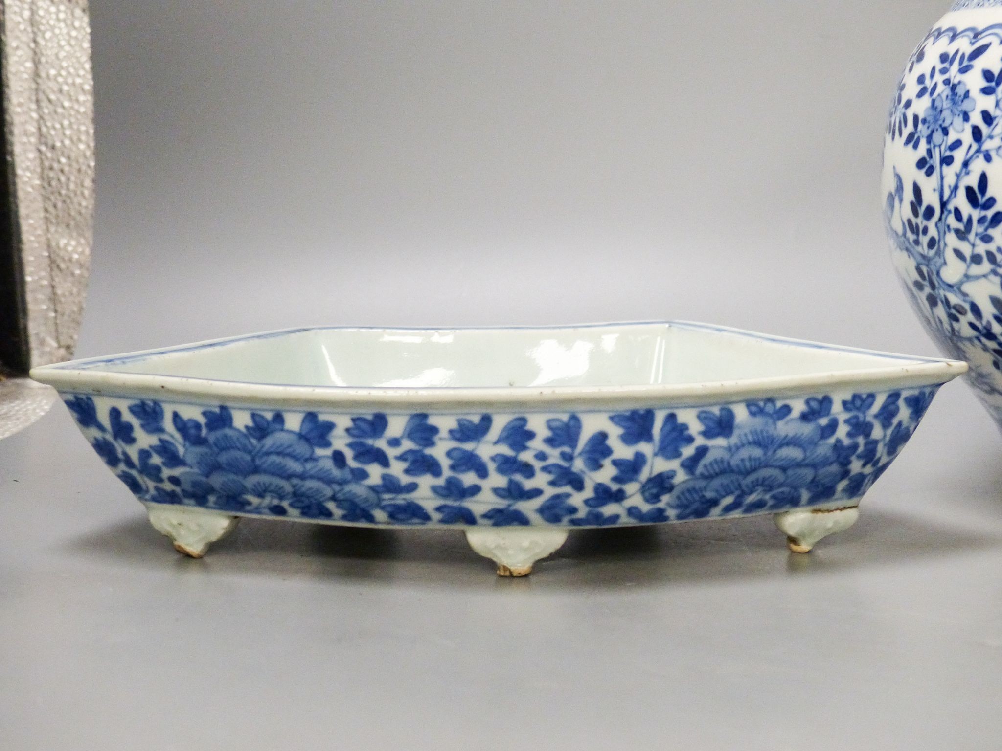 A 19th century Chinese blue and white jar and cover, four character Kangxi mark, 22cm high and a Chinese blue and white fan shape dish, 25.5cm